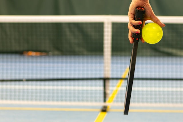 People playing a doubles pickleball game