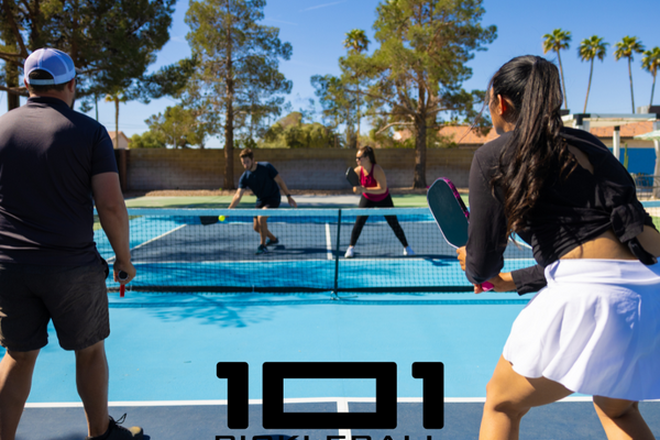 Pickleball players playing in a court.