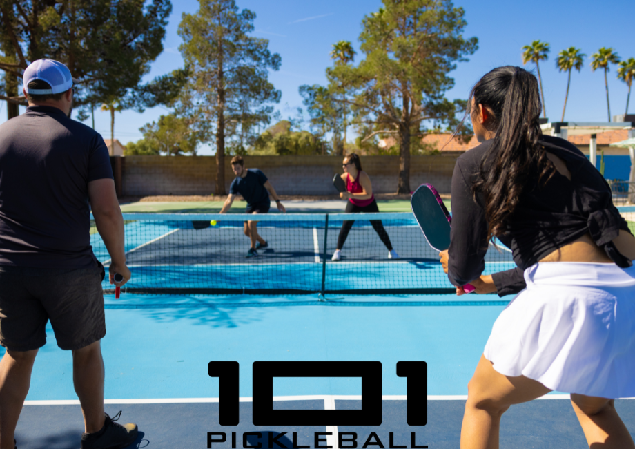 Pickleball players playing in a court.