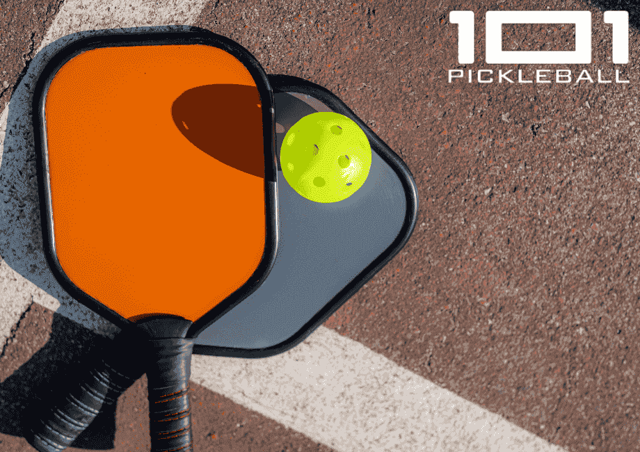 Pickleball paddles and ball in a court ground